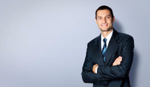 Happy smiling businessman with crossed arms pose
